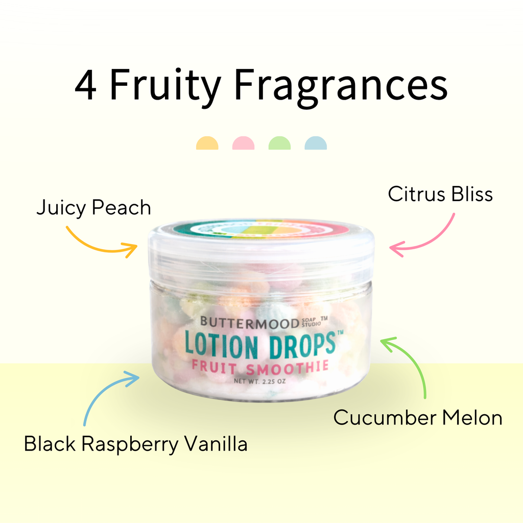 Buttermood Fruit Smoothie Lotion Drops showing four fruity fragrances (Juicy Peach, Citrus Bliss, Cucumber Melon, & Black Raspberry Vanilla) labeled on a cream and yellow background.